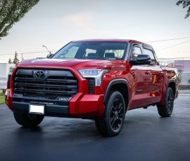 Red Toyota Tundra pickup truck parked in a lot, front-left angle, with a black grille and bold styling. Watermark reads BLUE STAR AUTOSALON in the corner.